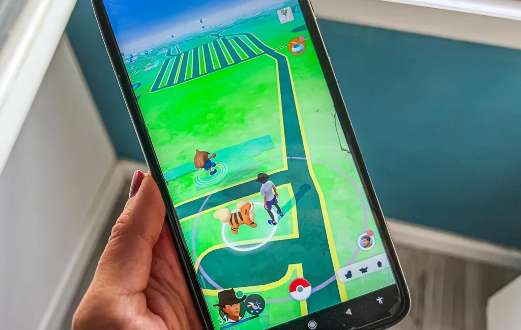 Pokémon Go app screenshot with players interacting in augmented reality.